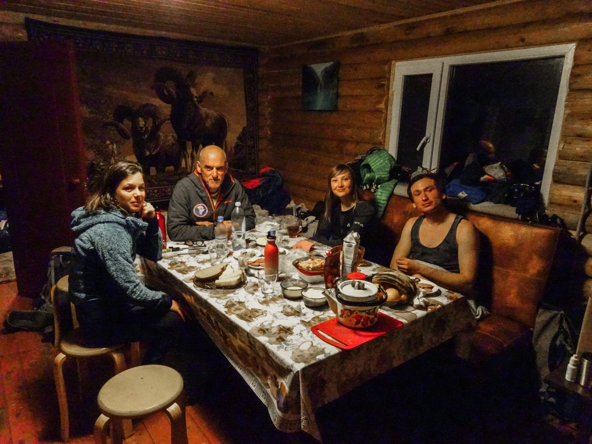 group of skiers having dinner at the mountain hut of Ketmen