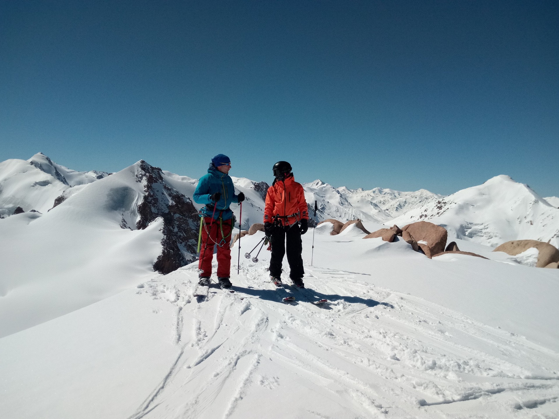 skiers on the top of Molodezhny peak in Tuyuksu