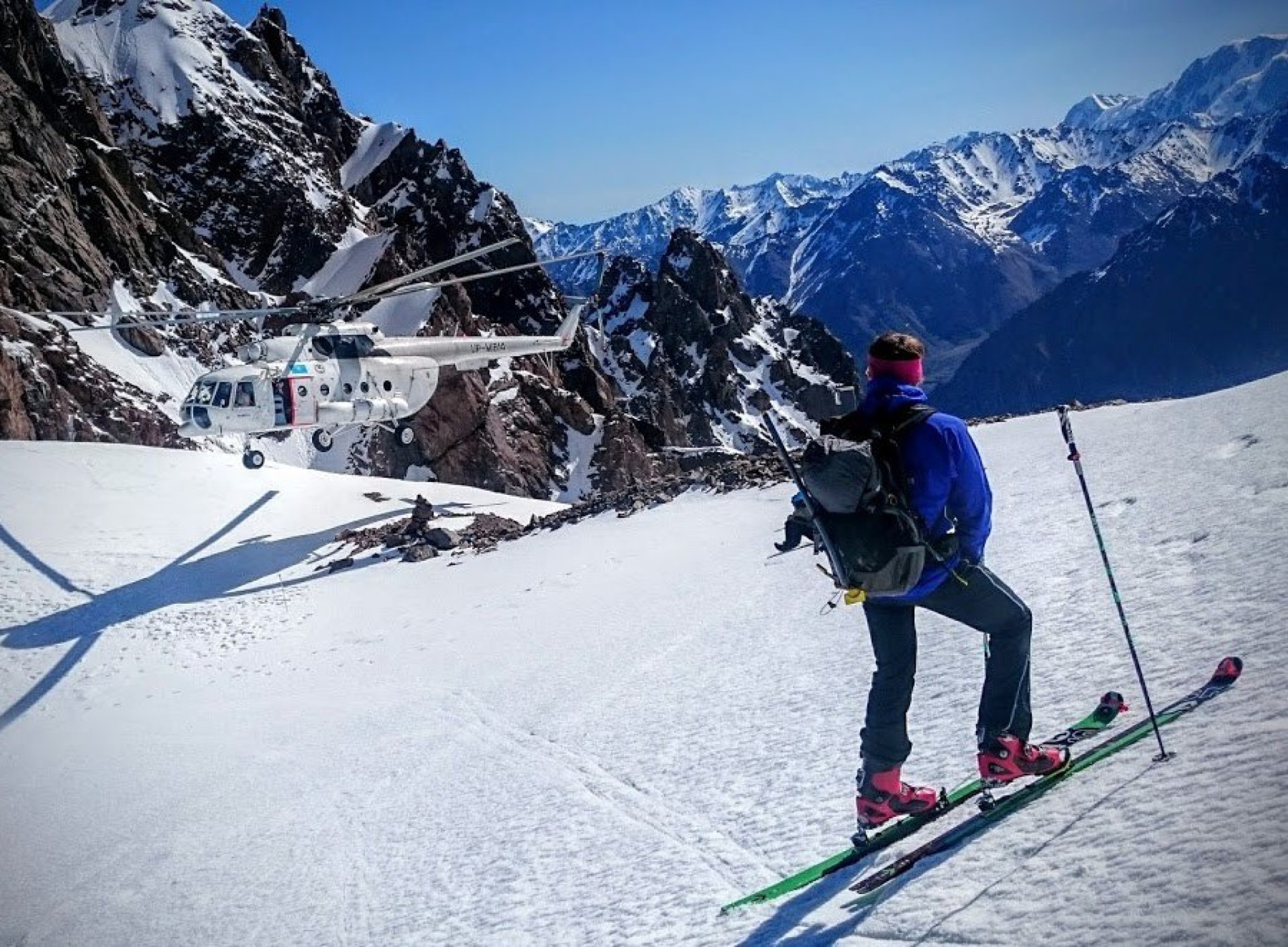 skier and a helicopter on Karlytau peak in Almaty Kazakhstan