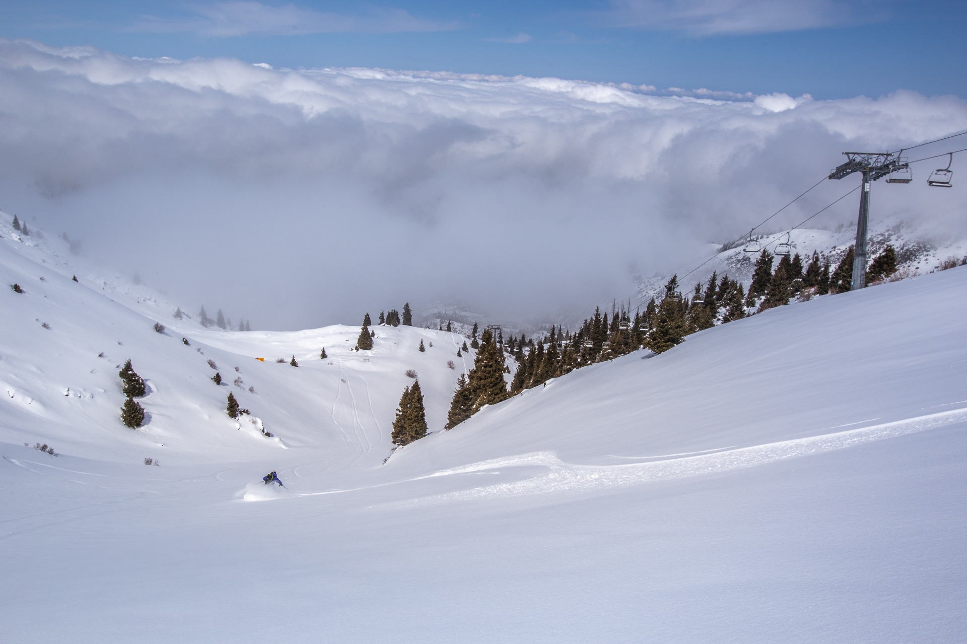 skiing under the ski lifts at Shymbulak ski resort