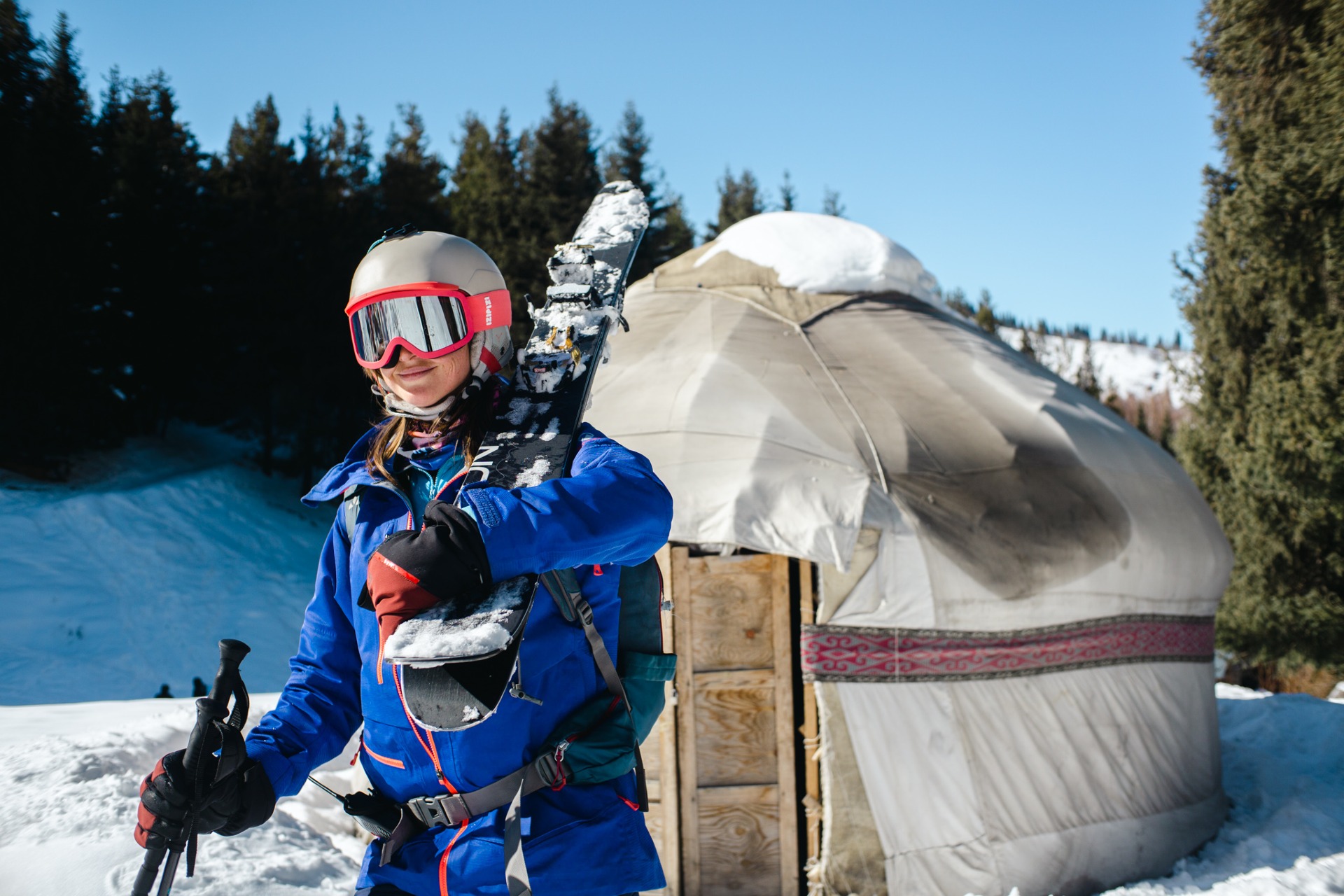 kazakh yurt and a skier in Butakovka gorge in Almaty, Kazakhstan