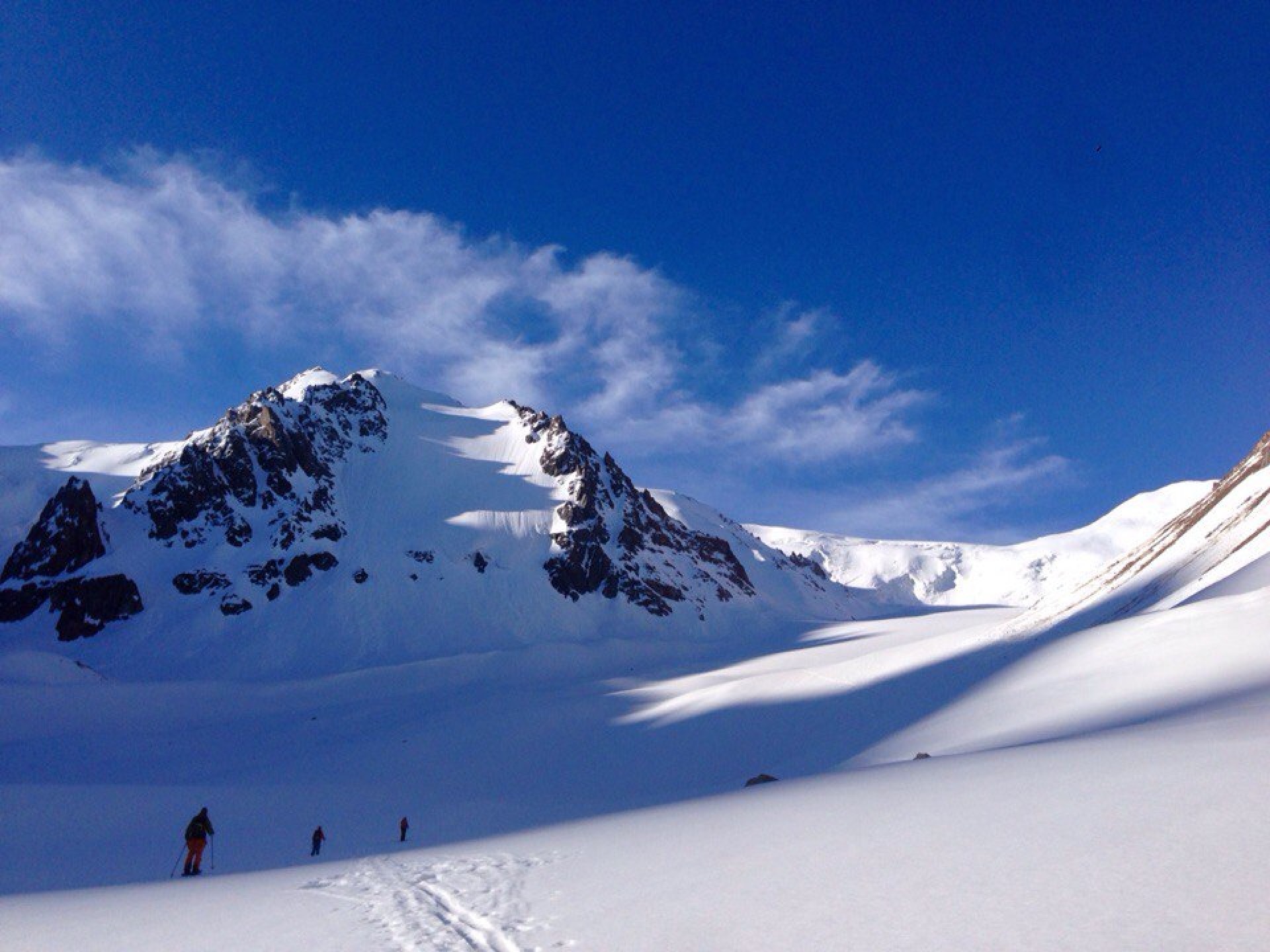 Tuyuk-su peak and skiers in Kazakhstan