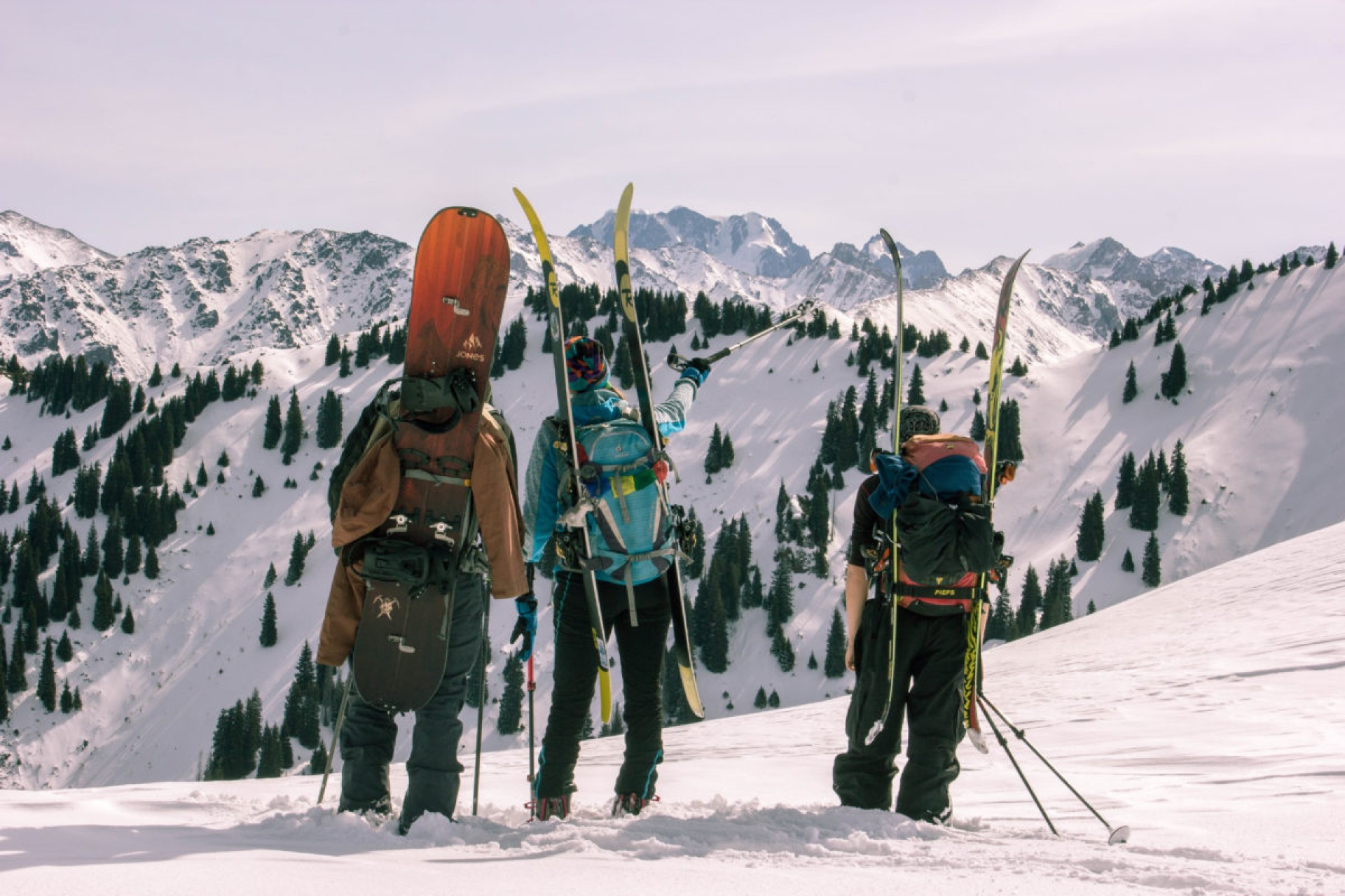 skiers and a snowboarder on Bukreev peak in Butakovka gorge Almaty